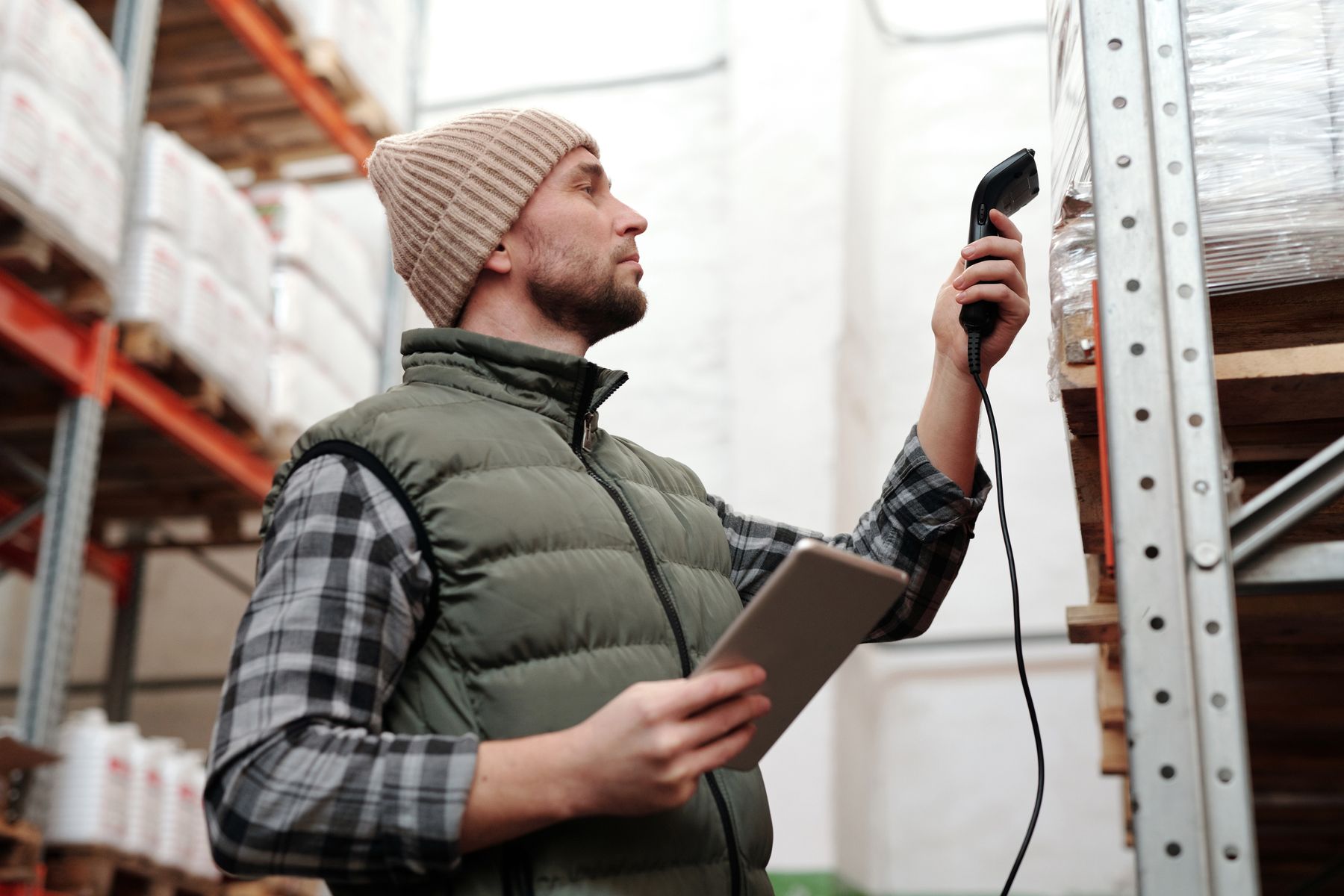 Warehouse worker using a handheld barcode scanner