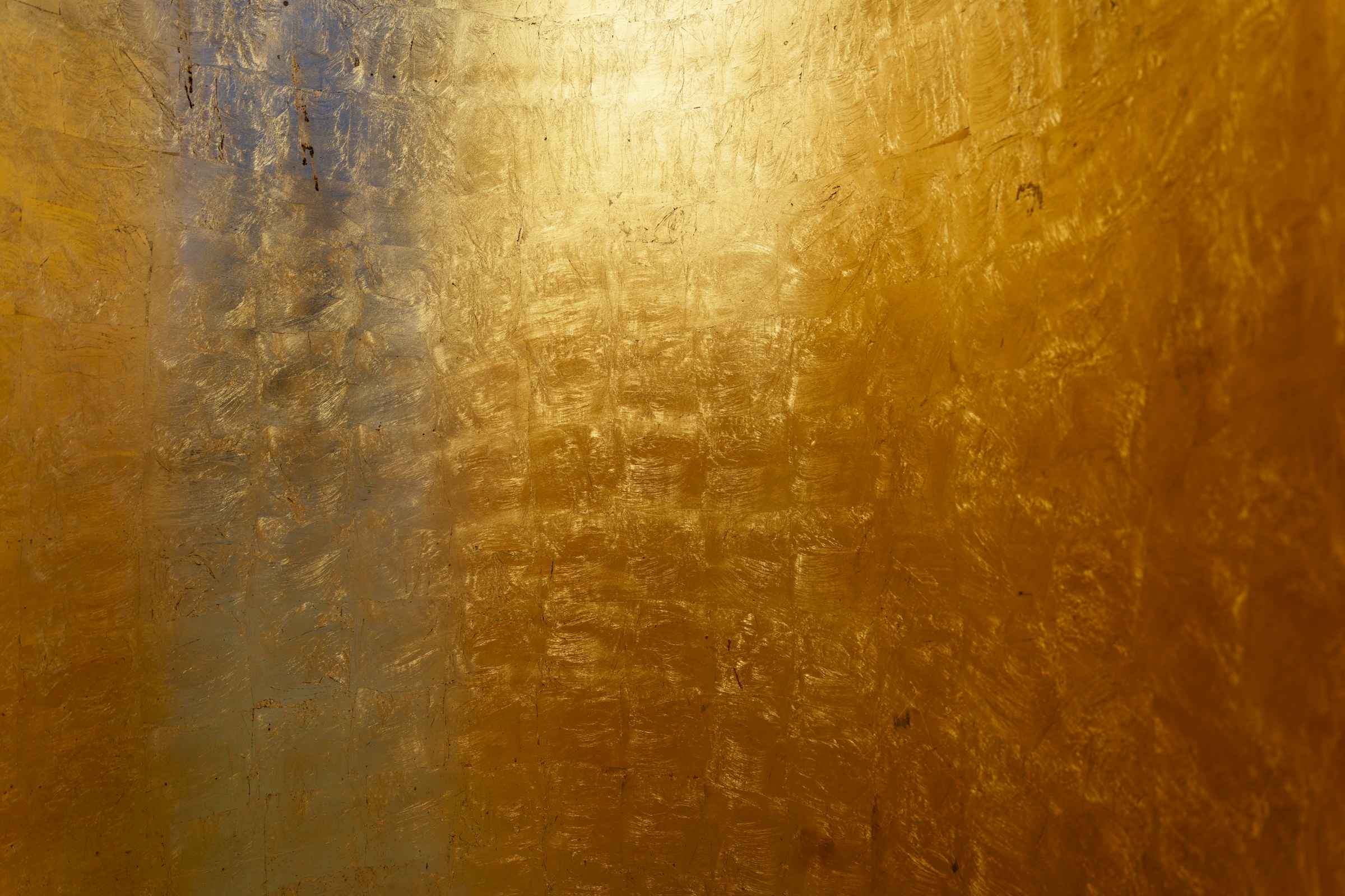 Abstract gold leaf texture representing a confidential precious-metals mobile platform